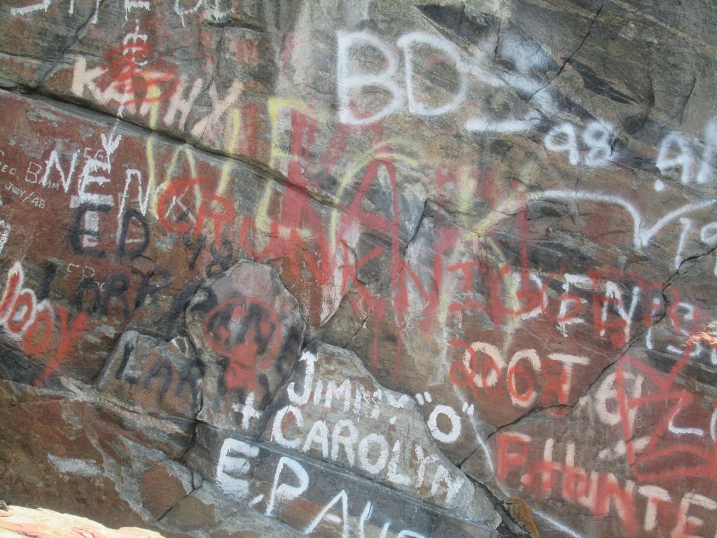  The red ochre pictographs are obliterated by graffiti on the face of the rock pictured below. 
