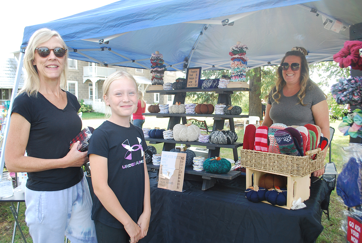 Carole St-Aubin, THE EQUITY Tracy Huckabone and her daughter McKenna shopping for hair scrunchies and other handmade items by Ashley Hodgins at the outdoor market held at Chez Fabie’s in Quyon on Saturday.