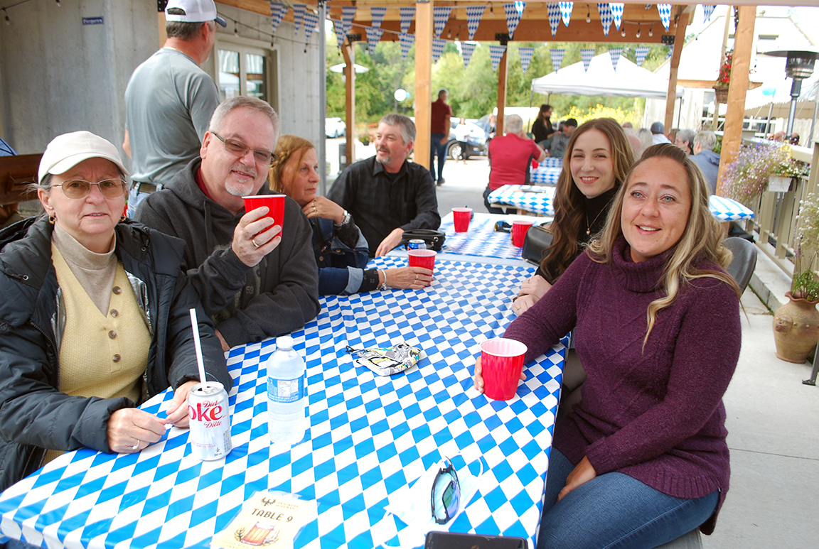 A group of friends gathered to enjoy the music, the food and the beer at the Oktoberfest festivities on Saturday. Pictured from front left are Ginette Savoie, Jacques Boissonneault, Thelma Morin and Charles Morin. At right, from front to back are Nathalie Savoie, Adèle Boisvert and Raymond Morin.